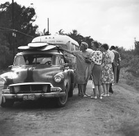 Ron Church, Sunset Beach Tourists, Women Looking At Surfboards On Car, Hawaii, circa 1963
